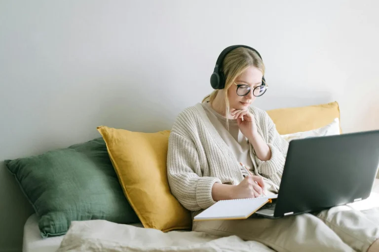 Mujer estudiando en casa con laptop y audífonos, representando el bachillerato técnico acelerado online en Ecuador con educación práctica